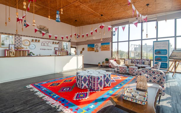 Seating area with colorful decor at Al Majles Resort reception.