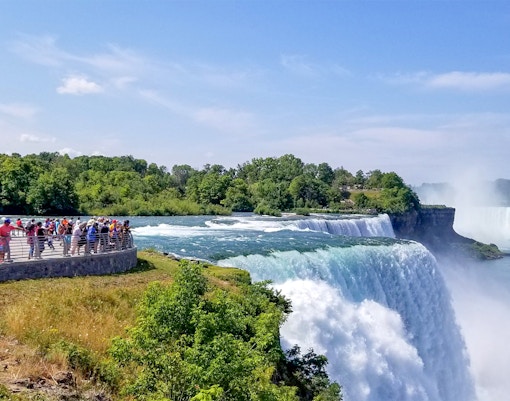 Tourists on Luna Island viewing Niagara Gorge through mist.