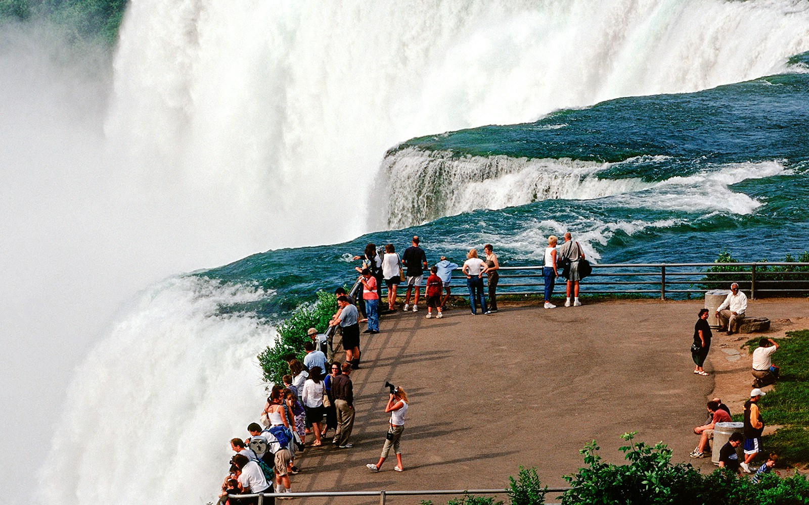 Visitors viewing Niagara Falls from Luna Island observation point.