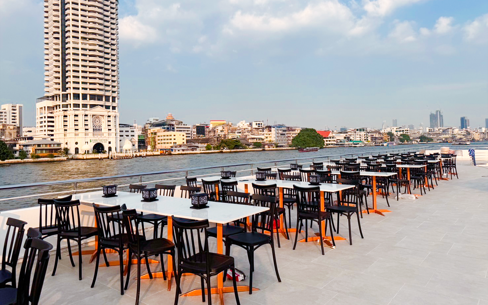 Luxury dinner cruise tables set on ICONSIAM riverboat, Bangkok, Thailand.