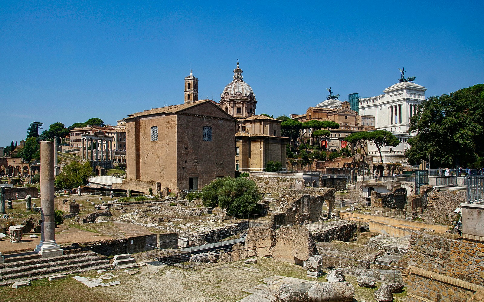 Mamertine Prison view from Via dei Fori Imperiali, showcasing ancient ruins and historic architecture.