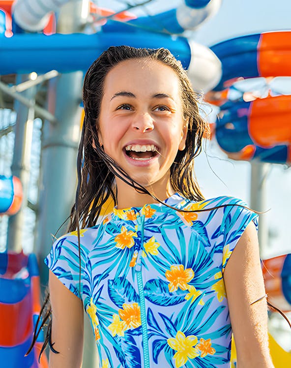 Child enjoying water park slides at Gold Coast during school holiday special.