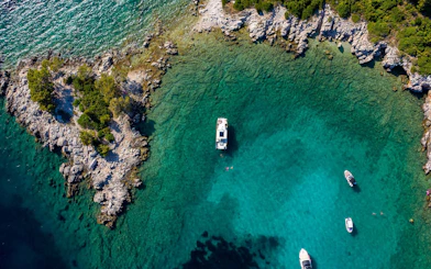 Aerial view of boats near rocky coastline of Koločep, Croatia.