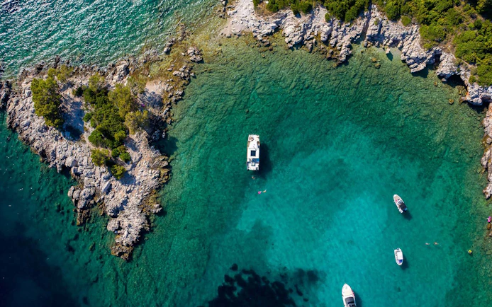 Aerial view of boats near rocky coastline of Koločep, Croatia.