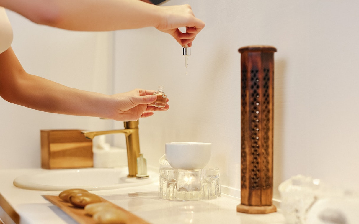 Hands preparing essential oils at Mandala Day Spa.