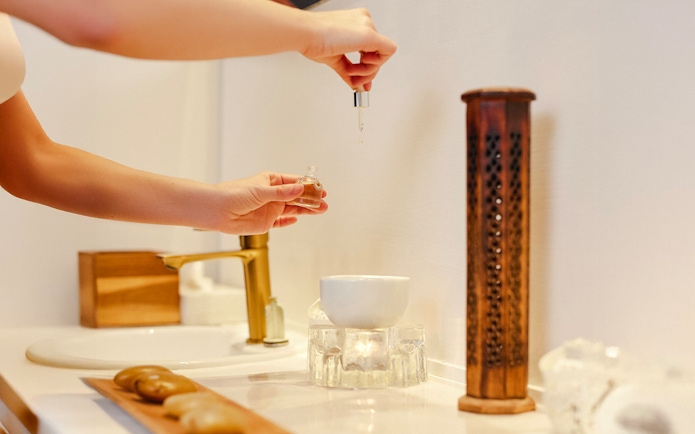 Hands preparing essential oils at Mandala Day Spa.