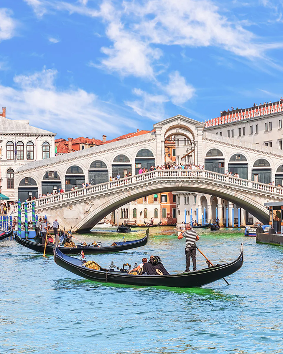 Gondolas on the Grand Canal with Rialto Bridge in Venice.