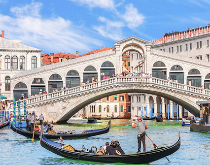 Gondolas on the Grand Canal with Rialto Bridge in Venice.