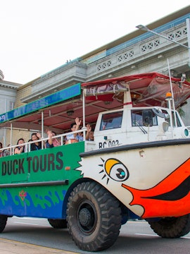Duck tours vehicle with passengers in Singapore, offering hop-on hop-off tickets.
