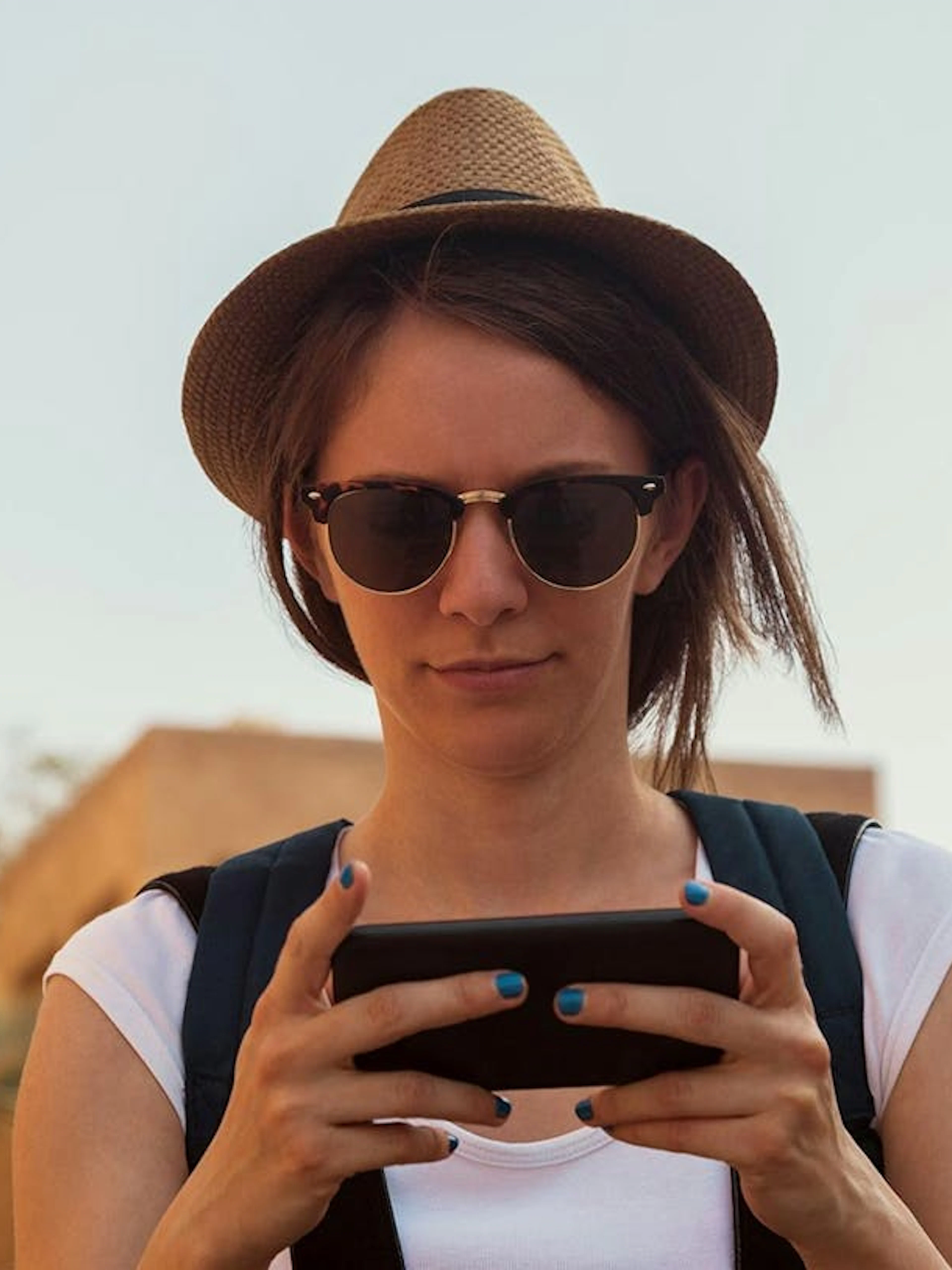 Tourist using smartphone for self-guided exploration in Old Dubai.