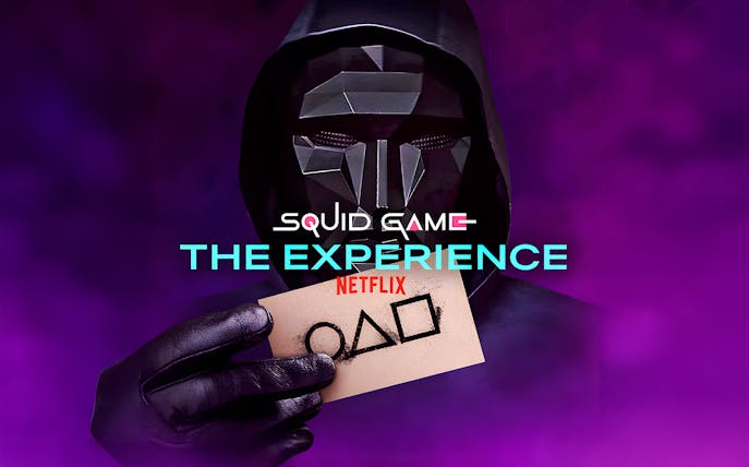 Mysterious figure holding card with symbols at Squid Game: The Experience in Sydney.