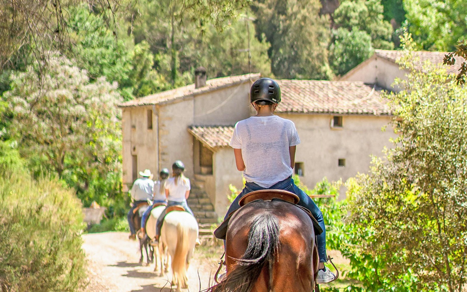 Horse riding tour with scenic views of Montserrat mountains, Spain.