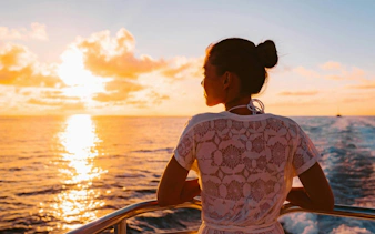 Tourist enjoying sunset on a private cruise in Ibiza.