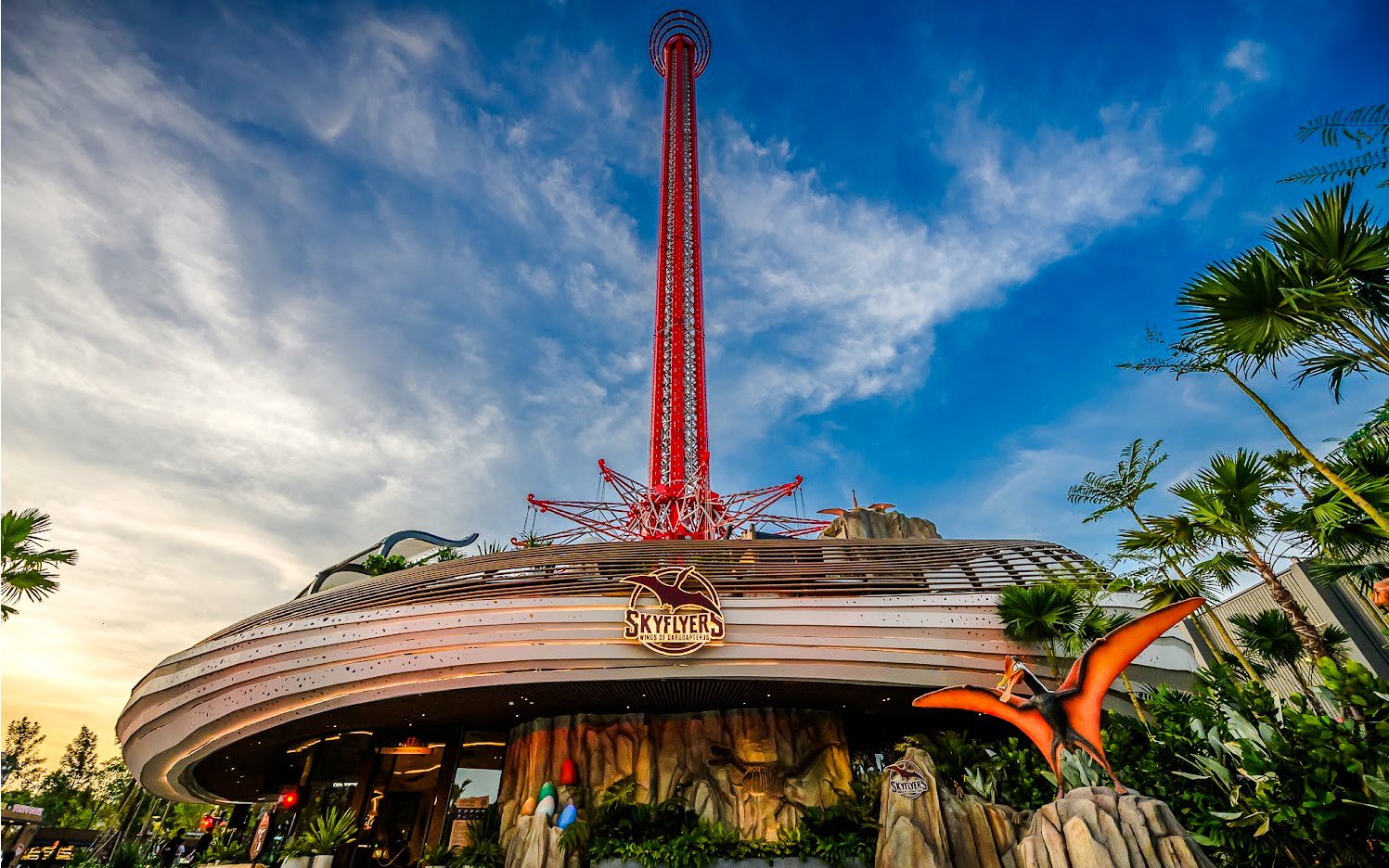 Wide angle view of SkyFlyer ride at Asiatique Bangkok with clear sky backdrop.