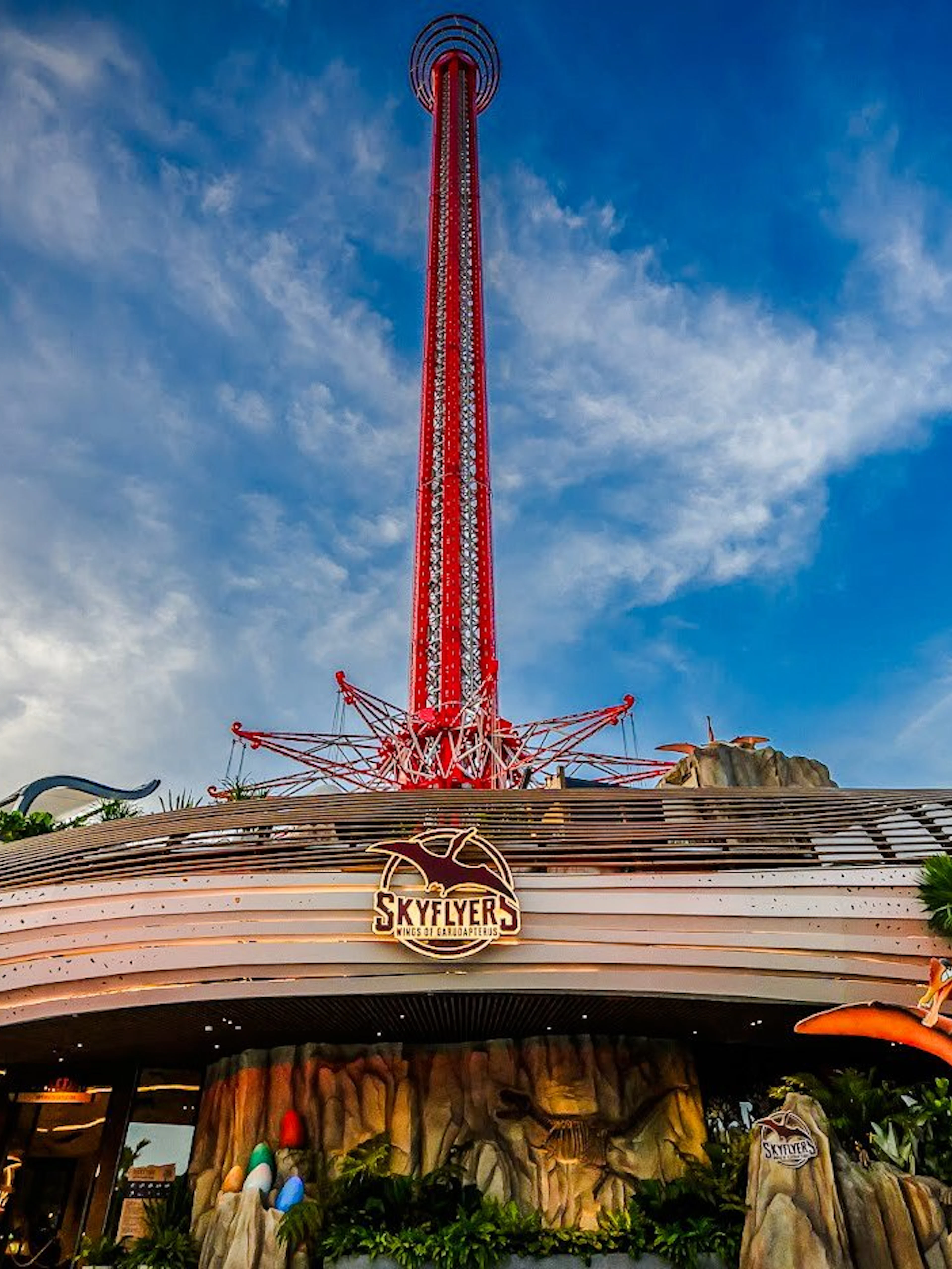 Wide angle view of SkyFlyer ride at Asiatique Bangkok with clear sky backdrop.