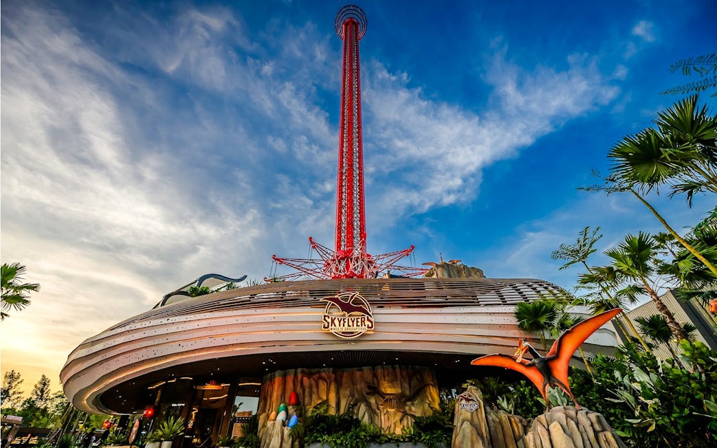 Wide angle view of SkyFlyer ride at Asiatique Bangkok with clear sky backdrop.