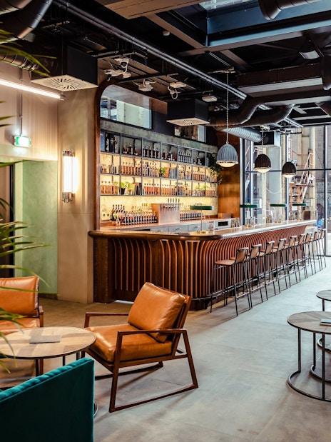 Roe & Co Distillery bar area with seating and modern decor.