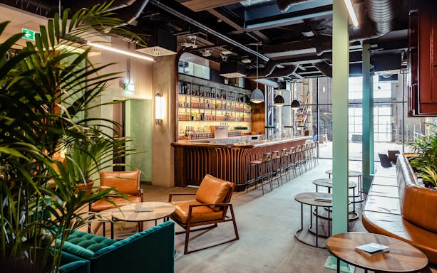 Roe & Co Distillery bar area with seating and modern decor.