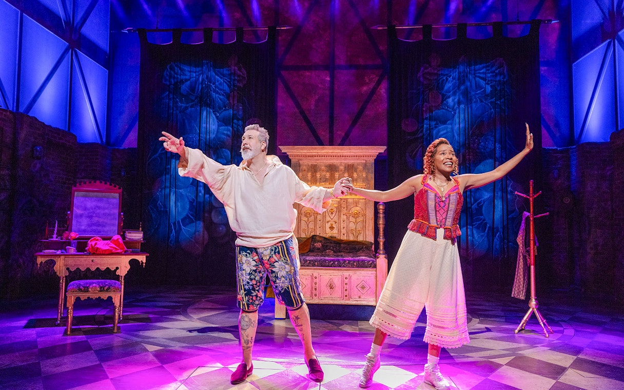 Performers on stage during "& Juliet" musical in vibrant costumes.