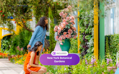 Guests admiring colorful flowers at New York Botanical Garden.