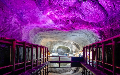 Salt Cathedral of Zipaquirá illuminated cave with water reflection.
