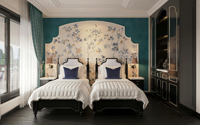 Twin beds in a luxury cabin with floral decor on La Casta Star Cruise, Lan Ha Bay.