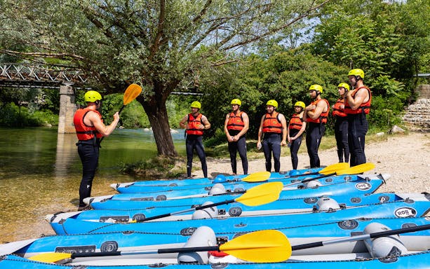 Canyoning group receiving instructions by the river in Split.