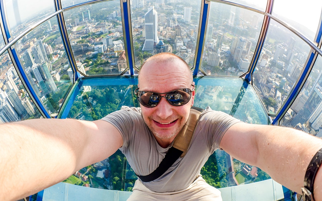 Visitor enjoying the view from KL Tower Skybox in Kuala Lumpur.