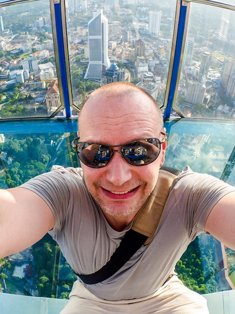 Visitor enjoying the view from KL Tower Skybox in Kuala Lumpur.