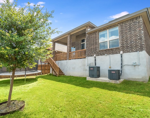 Back yard of a family house filled with green grass