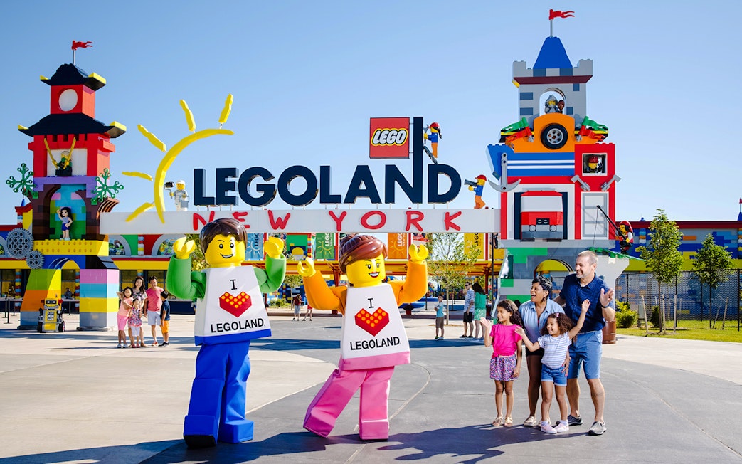 Guests enjoying the entrance of Legoland New York with colorful Lego structures.