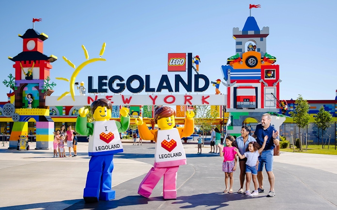 Guests enjoying the entrance of Legoland New York with colorful Lego structures.
