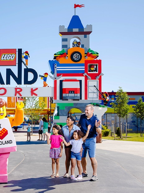 Guests enjoying the entrance of Legoland New York with colorful Lego structures.