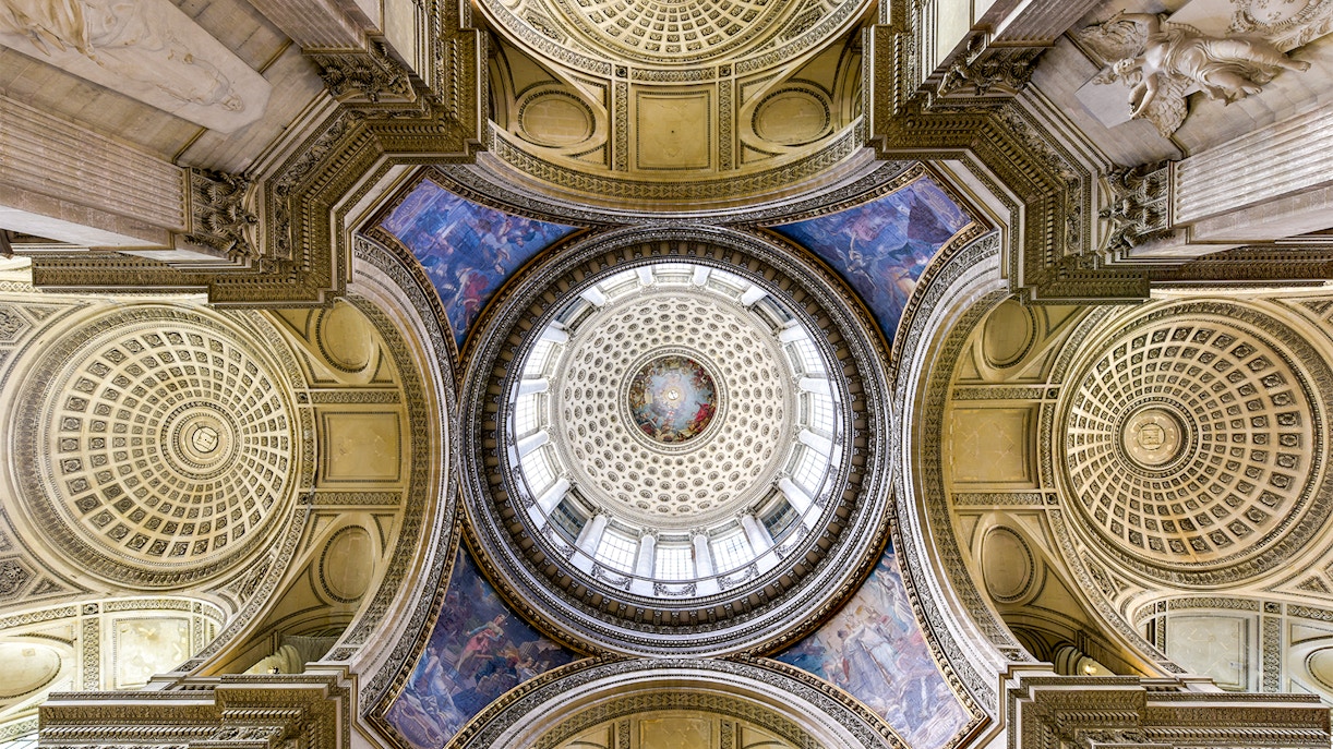 high ceilings and walls are adorned with beautiful artwork at Paris Pantheon