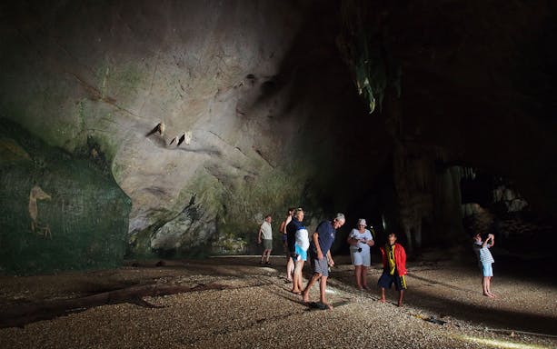 Tourists exploring a cave in Phang Nga Bay during a private charter from Phuket.
