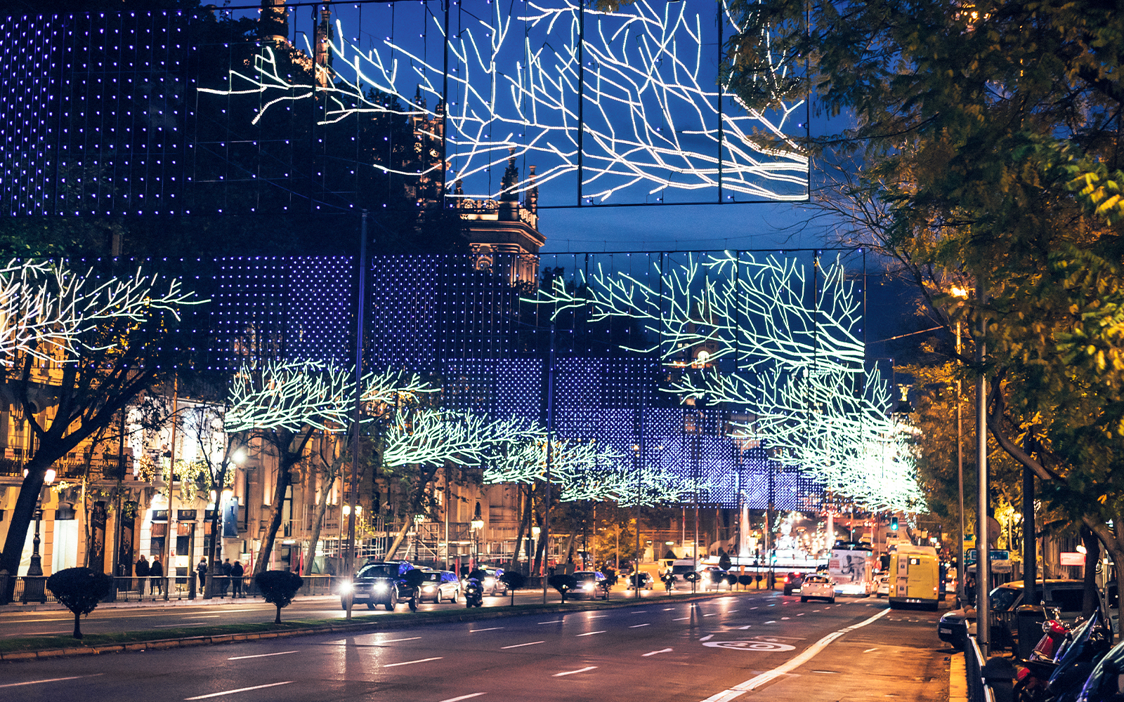 Christmas lights illuminating a street in Madrid during a bus tour.