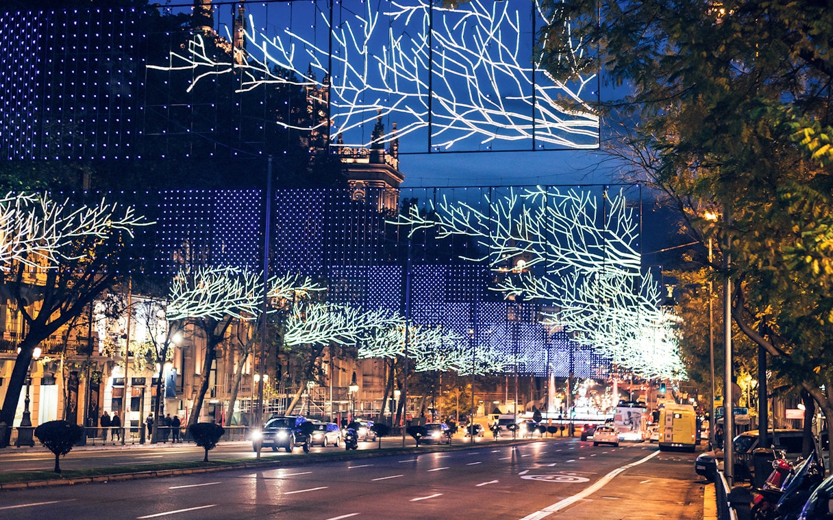 Christmas lights illuminating a street in Madrid during a bus tour.