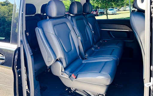 Mercedes E Class interior with black leather seats and spacious rear seating.