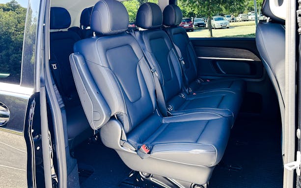 Mercedes E Class interior with black leather seats and spacious rear seating.