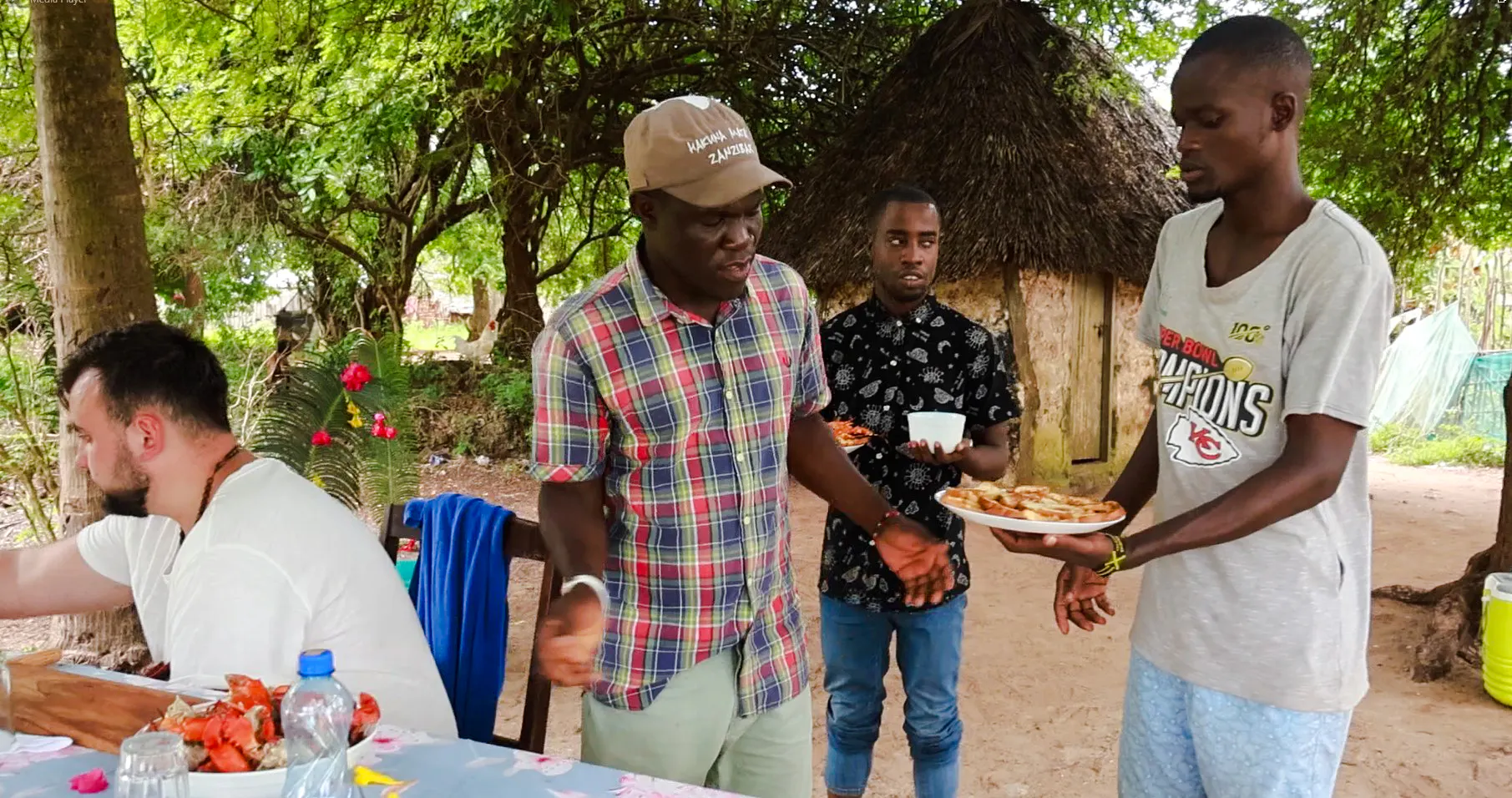 Guests enjoying lunch under trees on Funzi Island during Diani Beach excursion.