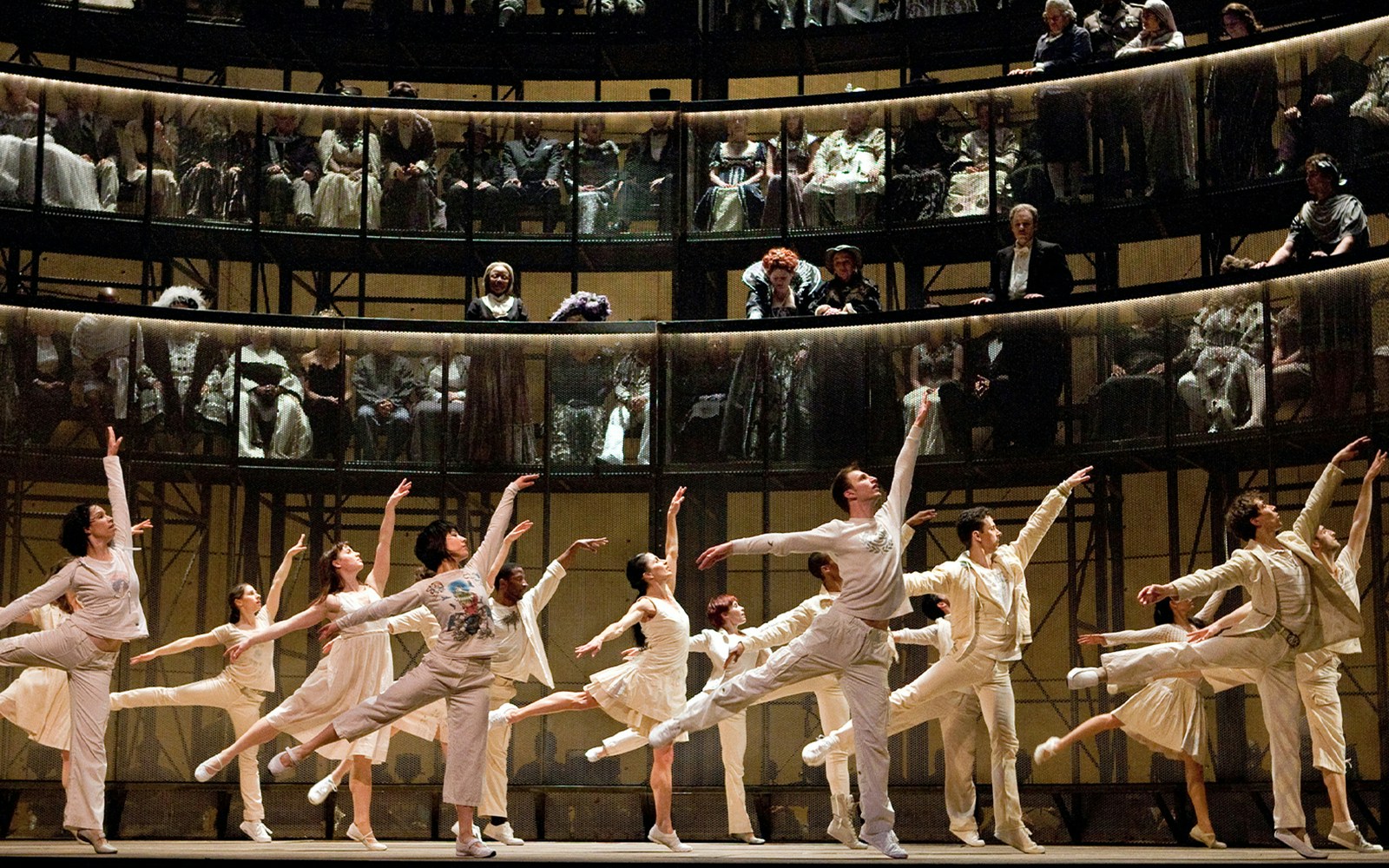 Ballet dancers performing Orfeo ed Euridice on stage with an audience in the background.