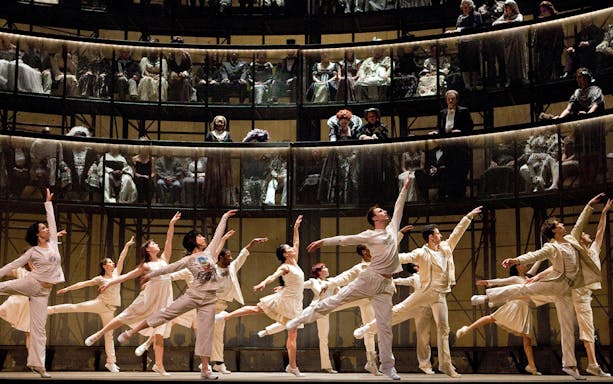 Ballet dancers performing Orfeo ed Euridice on stage with an audience in the background.