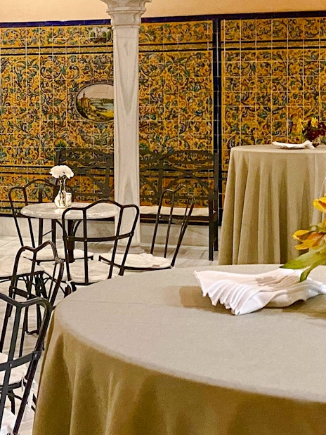 Dining tables with floral centerpieces at Triana Theater.
