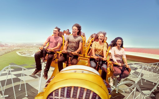 Visitors enjoying a roller coaster at Ferrari World Abu Dhabi.