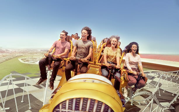 Visitors enjoying a roller coaster at Ferrari World Abu Dhabi.