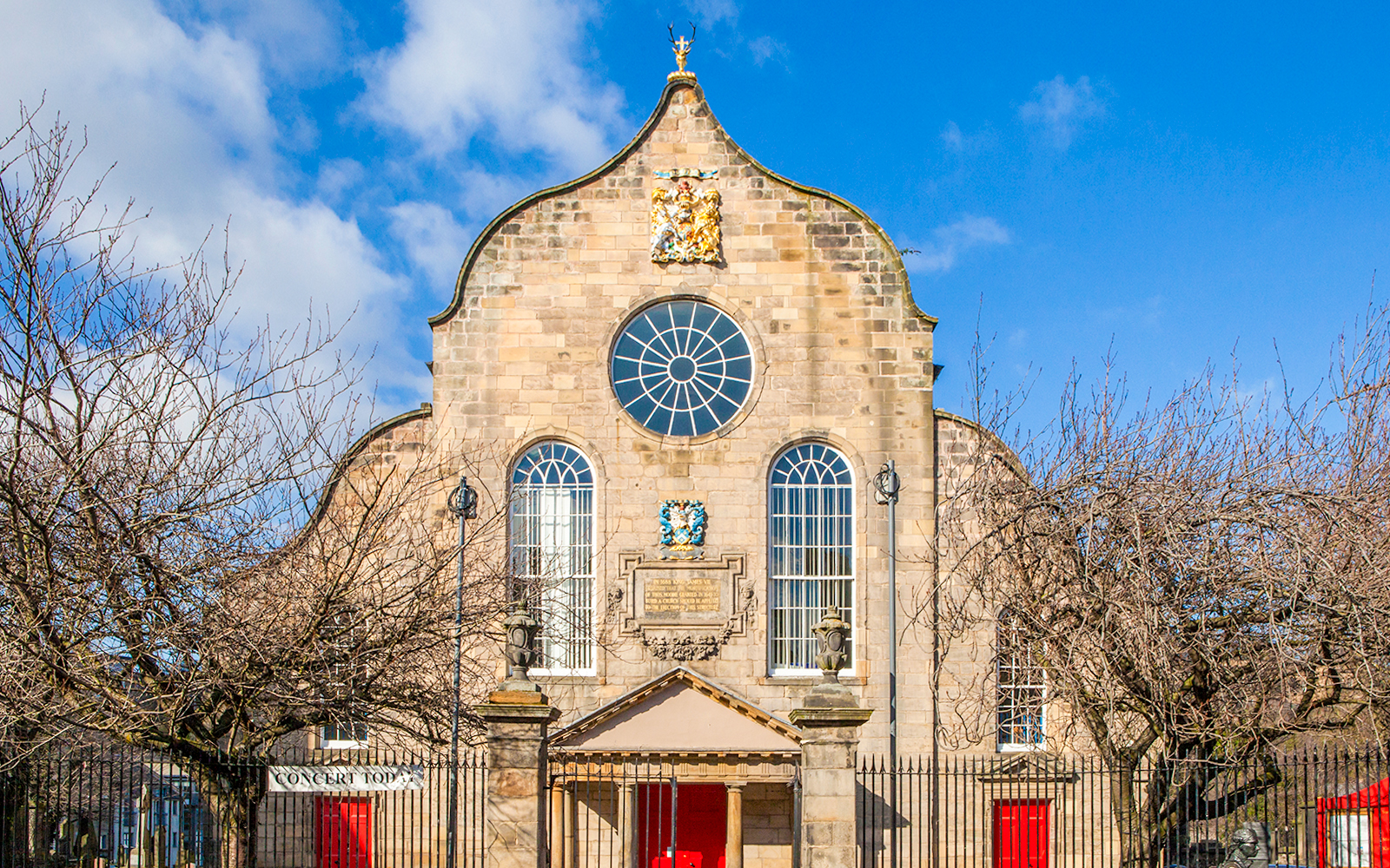 Canongate Kirk in Edinburgh with historic architecture and surrounding greenery.