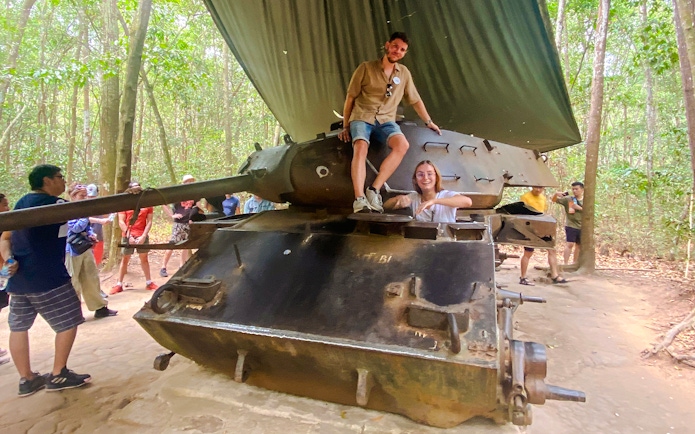 Tour group exploring a tank at Cu Chi tunnels, Vietnam.