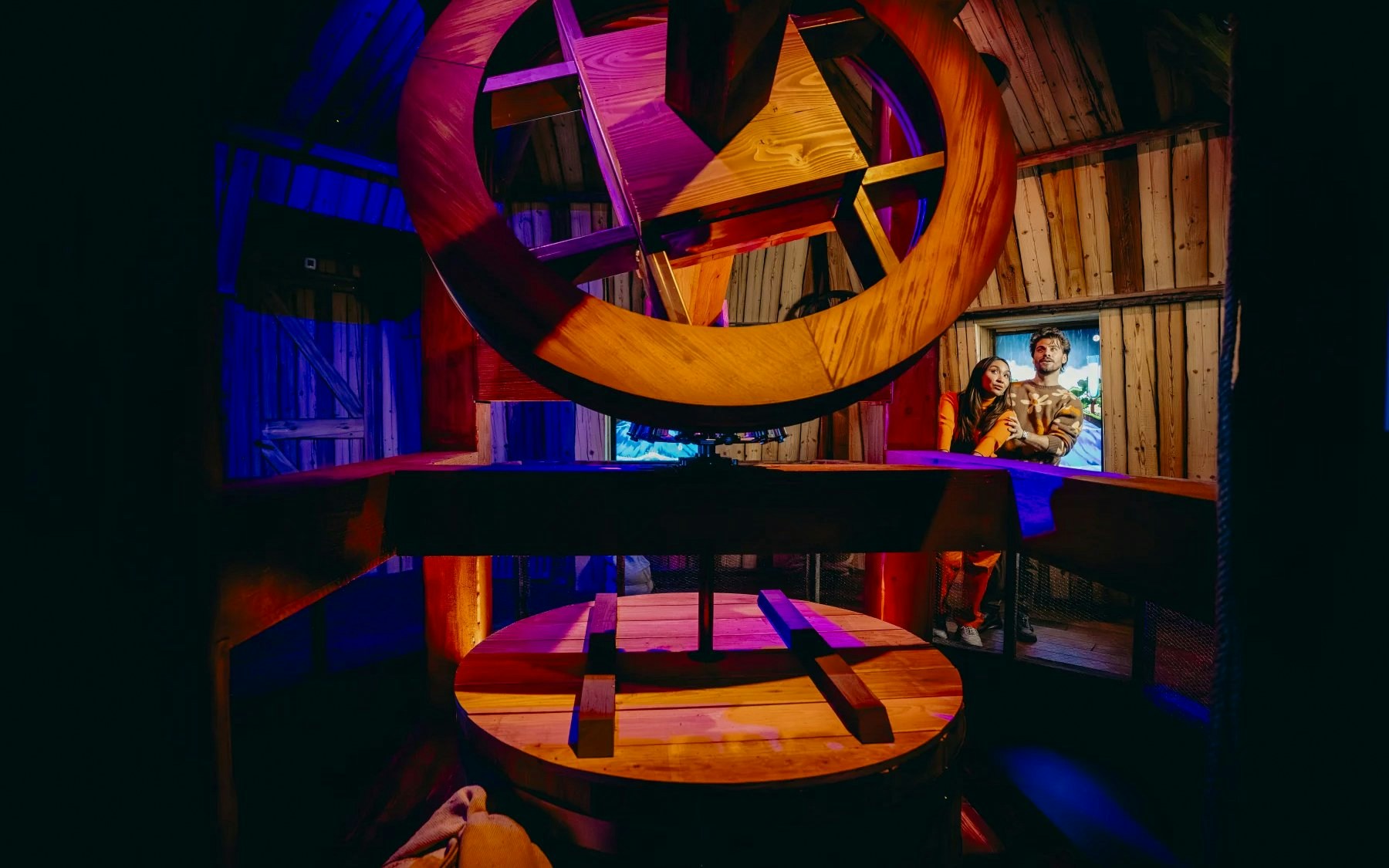 Interior of Windmill Room at Highlights of Holland with large wooden gears and visitors observing.