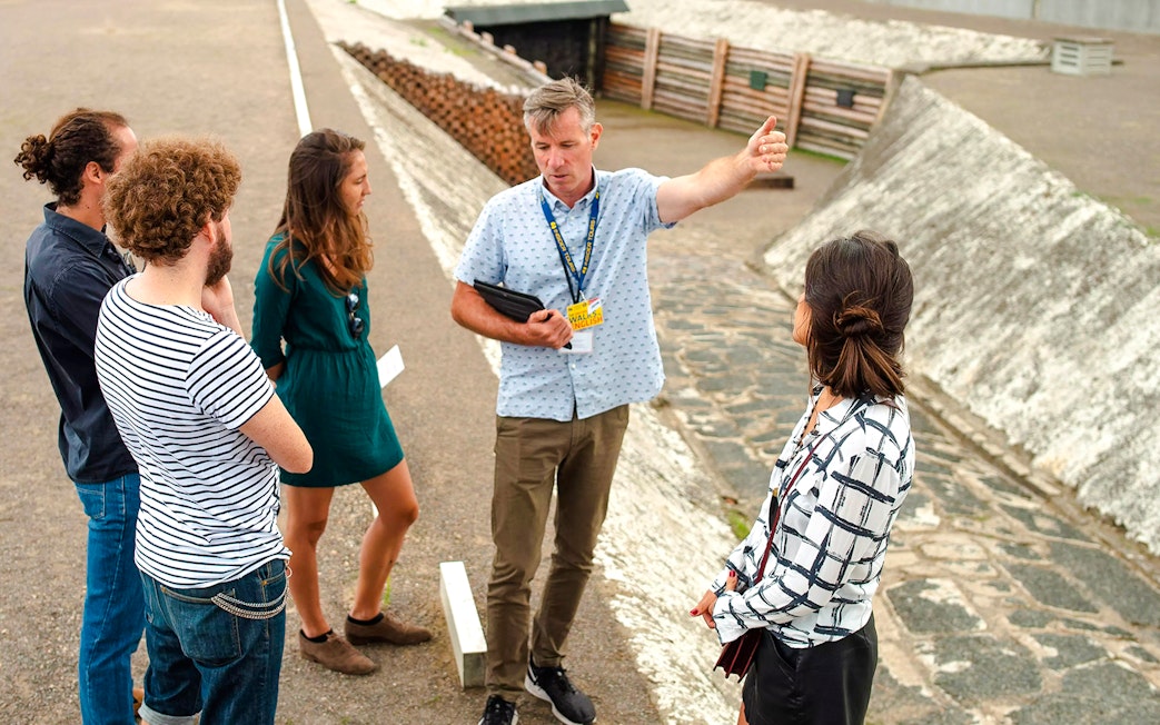 Guests with a tour guide at Sachsenhausen Concentration Camp Memorial, Germany.