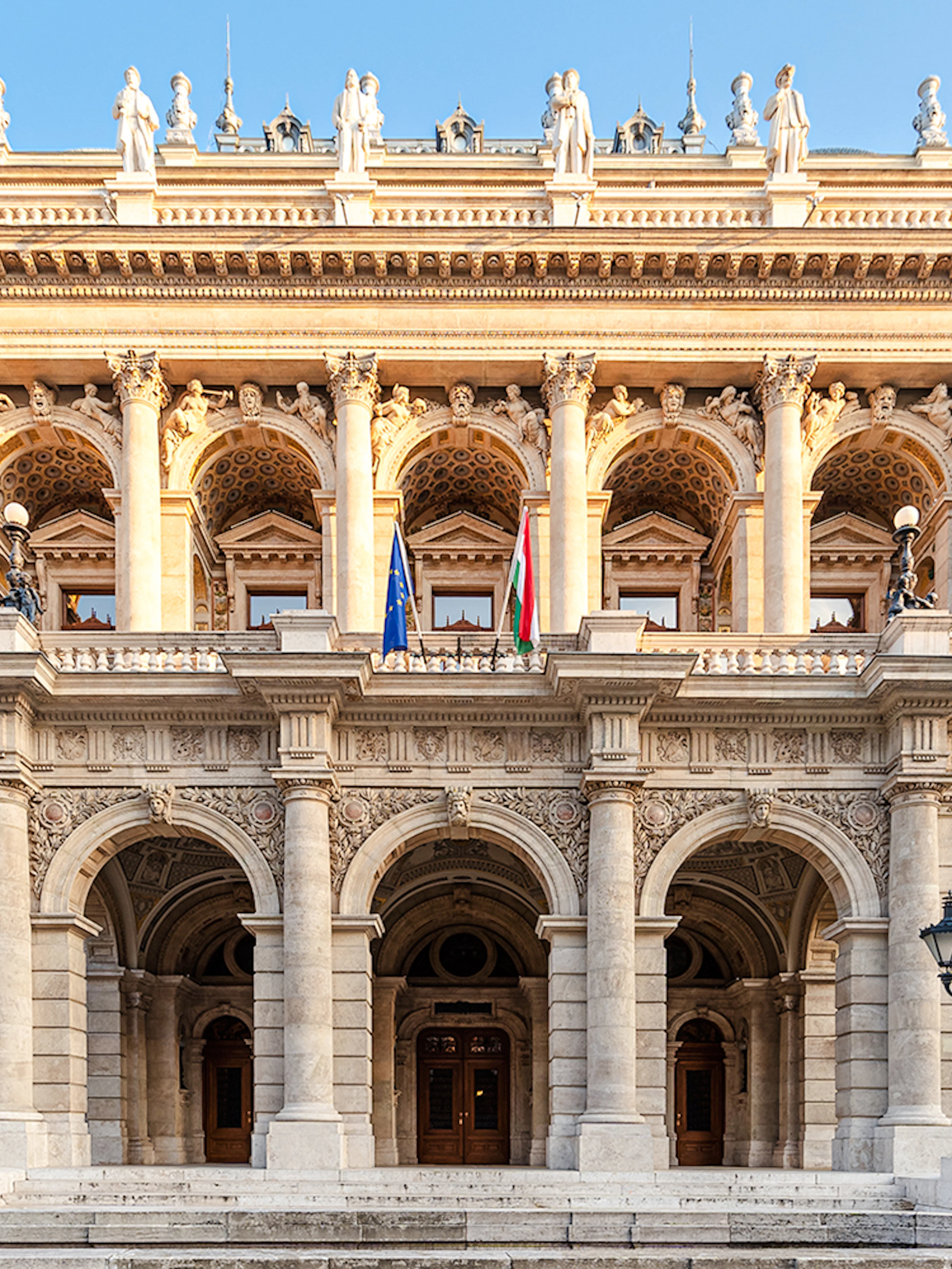 Hungarian State Opera exterior with ornate columns and statues, Budapest.
